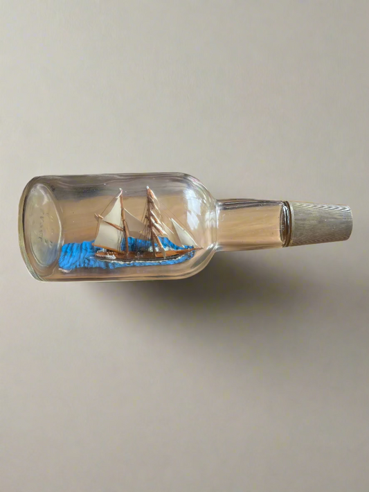 Model ship inside a bottle on a wooden surface
